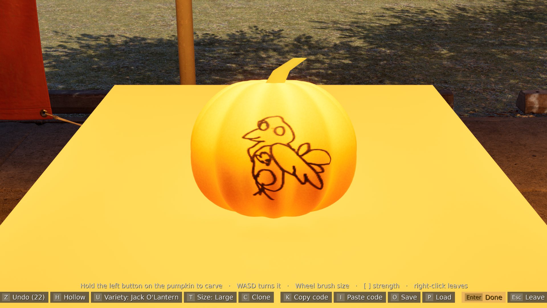 A pumpkin on the carving bench with a crow painted on it